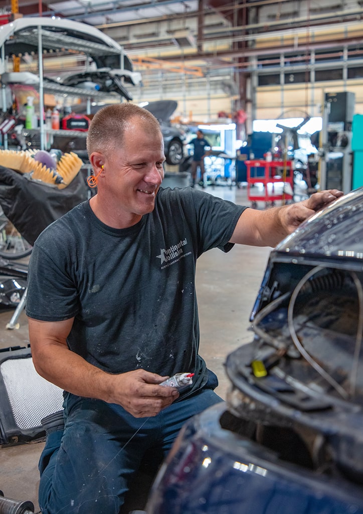 Continental Collision Technician Working on Brake Light